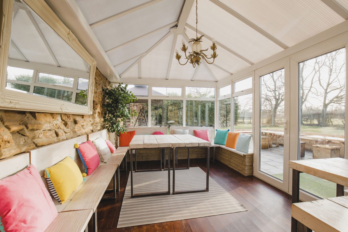 Wide angle view of the interior of a modern looking conservatory.